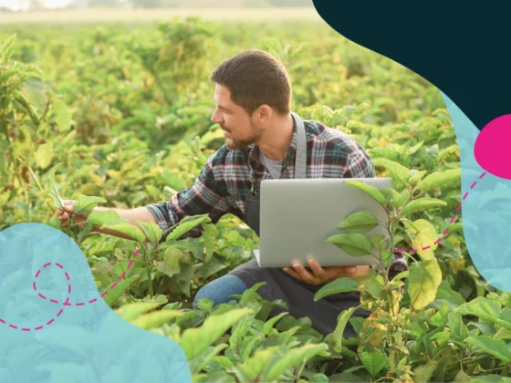 Man looking at plants and analysing them on the computer