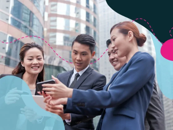 Four people working together outdoors in a city