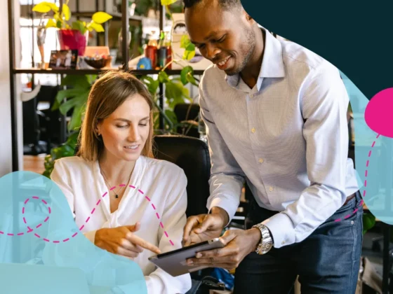 Two work colleagues looking at something on a tablet