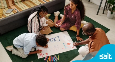 A family drawing a poster with the words "I have a dream"