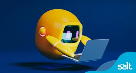 Yellow animated robot reading on a laptop