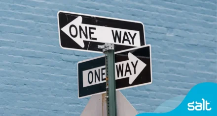 Close up of "One Way" roadway signs on a pole