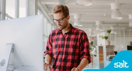 Man at a standing desk working on a computer