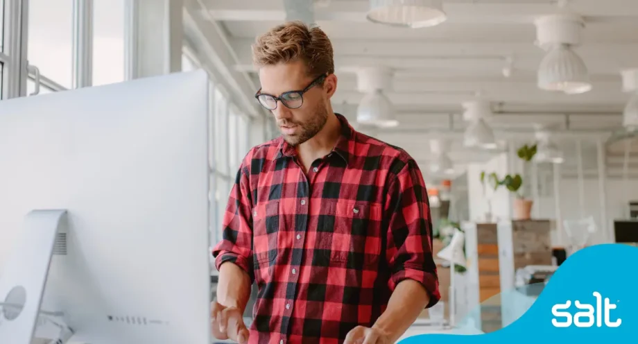 Man at a standing desk working on a computer
