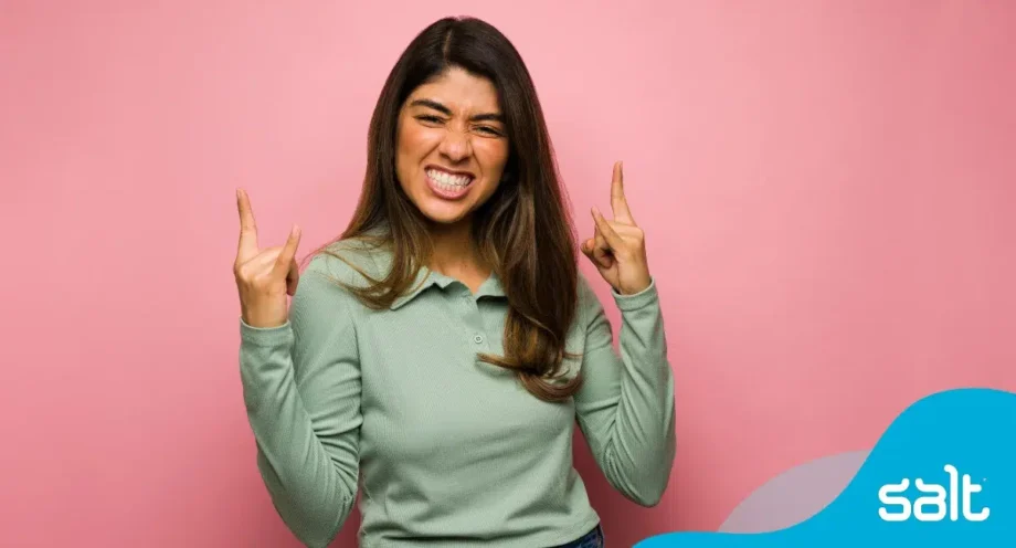 Woman standing with her fingers crossed for good luck looking excited