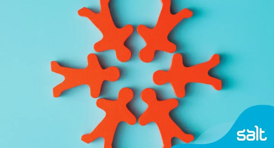 Orange wooden toy figures placed in a circle, symbolising people and diversity