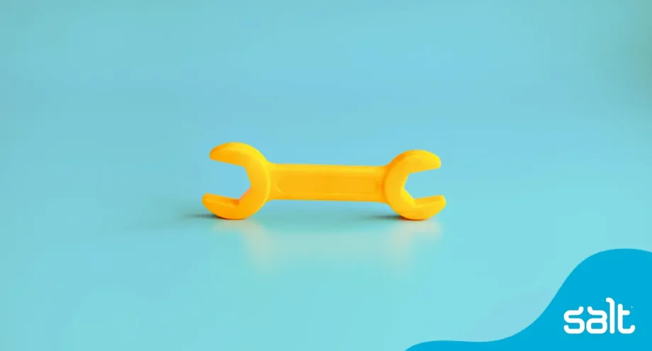 Yellow open ended spanner on blue background