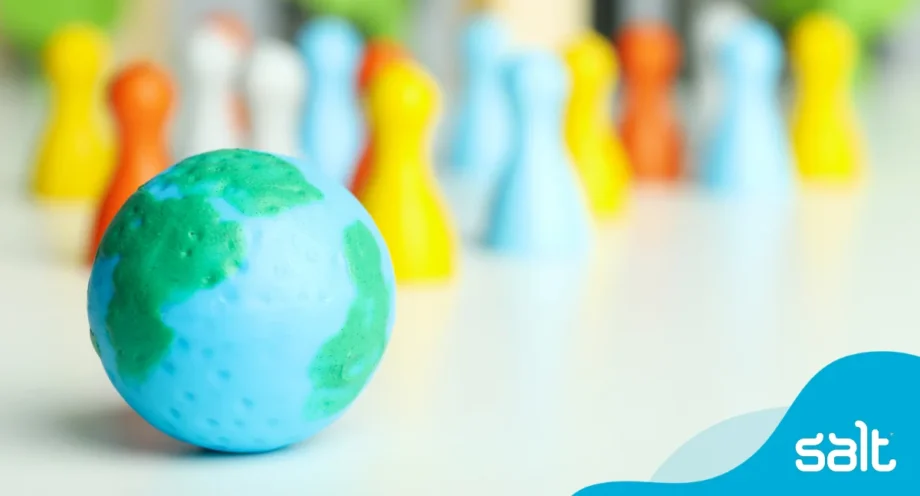 Globe on a table with colourful chess pieces