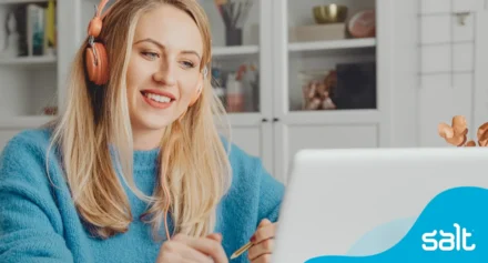 Woman with headphones in a virtual meeting working remotely