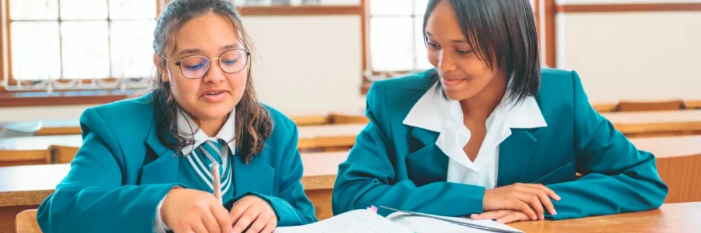 Spirit Education Foundation learners sitting at a school desk.