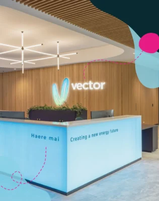 Vector logo lit up on office interior at the front desk