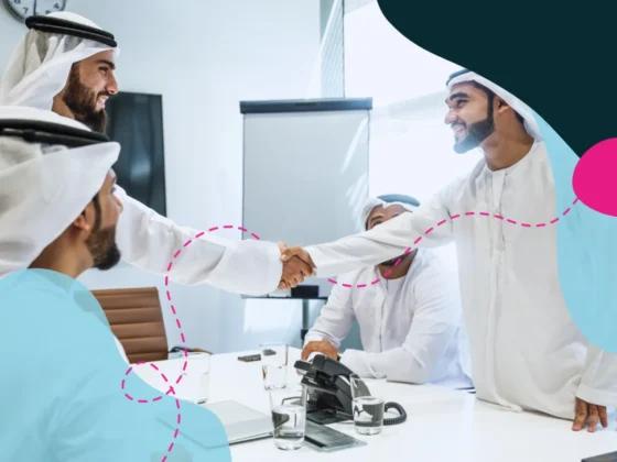 Emirati business men shaking hands in a boardroom meeting